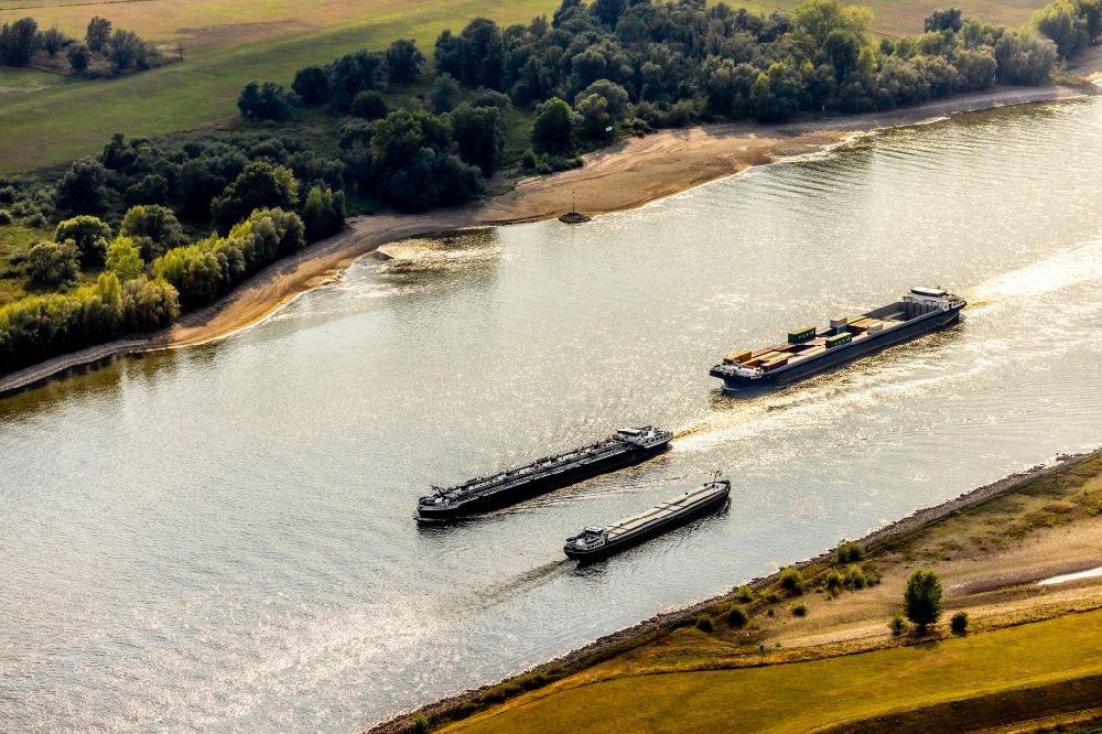 Aerial image Haldern - Ships and tugboats of inland navigation with reduced loads in the narrowed due to drought and low water level fairway on the waterway on the Rhine river in Haldern in the state North Rhine-Westphalia, Germany