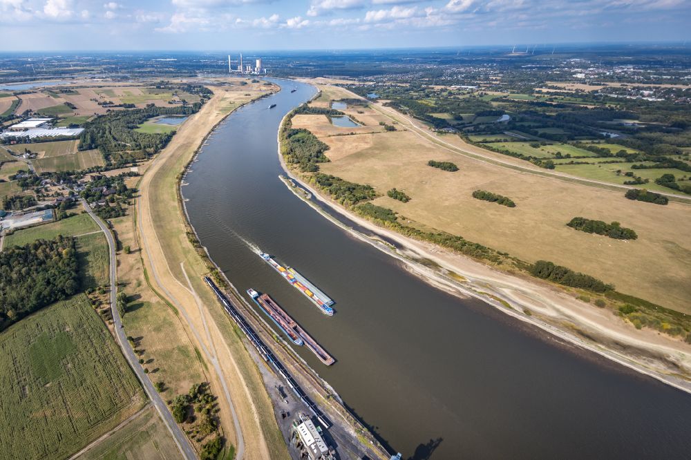 Aerial image Orsoy - Ships and tugboats of inland navigation with reduced loads in the narrowed due to drought and low water level fairway on the waterway on the Rhine river in Orsoy in the state North Rhine-Westphalia, Germany