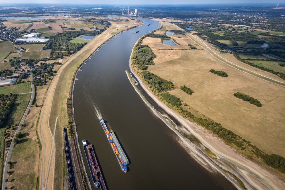 Aerial photograph Orsoy - Ships and tugboats of inland navigation with reduced loads in the narrowed due to drought and low water level fairway on the waterway on the Rhine river in Orsoy in the state North Rhine-Westphalia, Germany