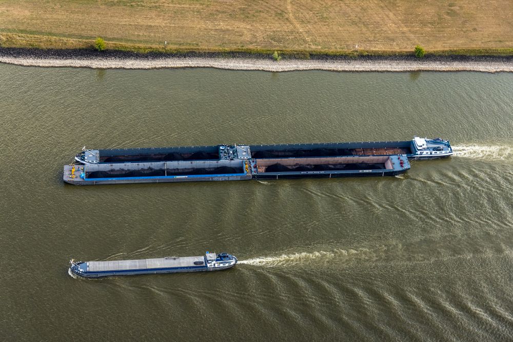 Aerial photograph Rees - Ships and tugboats of inland navigation with reduced loads in the narrowed due to drought and low water level fairway on the waterway on the Rhine river in Rees in the state North Rhine-Westphalia, Germany