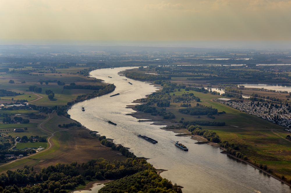 Wesel from above - Ships and tugboats of inland navigation with reduced loads in the narrowed due to drought and low water level fairway on the waterway on the Rhine river in Wesel at Ruhrgebiet in the state North Rhine-Westphalia, Germany