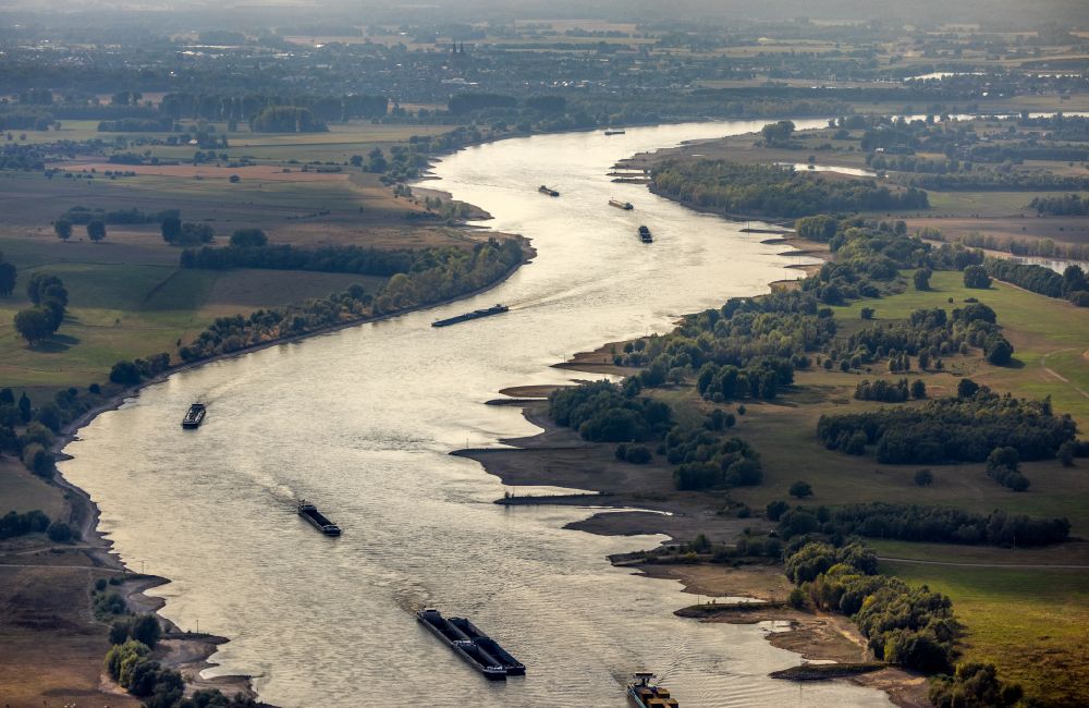 Aerial image Wesel - Ships and tugboats of inland navigation with reduced loads in the narrowed due to drought and low water level fairway on the waterway on the Rhine river in Wesel at Ruhrgebiet in the state North Rhine-Westphalia, Germany