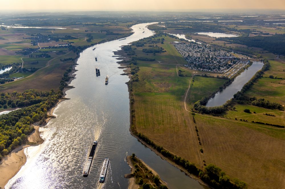 Wesel from above - Ships and tugboats of inland navigation with reduced loads in the narrowed due to drought and low water level fairway on the waterway on the Rhine river in Wesel at Ruhrgebiet in the state North Rhine-Westphalia, Germany