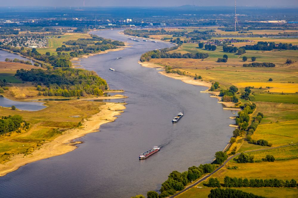 Aerial image Xanten - Ships and tugboats of inland navigation with reduced loads in the narrowed due to drought and low water level fairway on the waterway on the Rhine river in Xanten in the state North Rhine-Westphalia, Germany