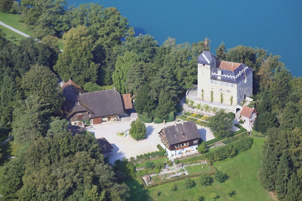 Buonas from the bird's eye view: Idyllic situated at Lake Zug is the Buonas Castle on the peninsula Buonas in Risch in Switzerland. The Buonas Castle, also known as Castle Hertenstein, serves as a training center for managment people of the pharmaceutical company Roche