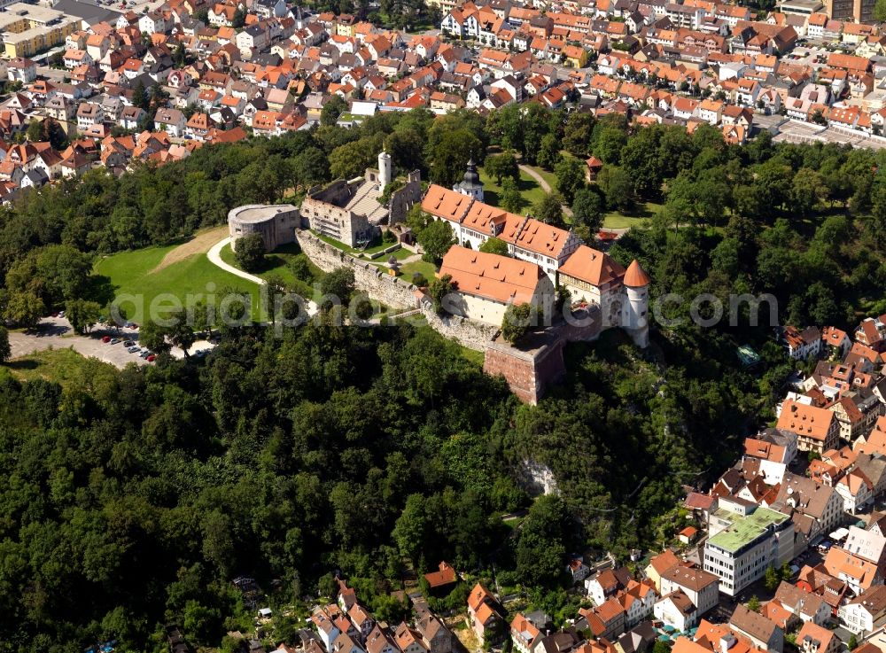 Aerial photograph Heidenheim an der Brenz - Castle Hellenstein in the town of Heidenheim an der Brenz in the state of Baden-Wuerttemberg. The fortress is located on a hill in the South of the town, surrounded by residential buildings. The fortress was first built in the 11th century. Its elaborate ruins are the remains of a knight's hall which are today used for operas. Apart from this, the castle is today home to the museum of local history and the state museum of Wuerttemberg