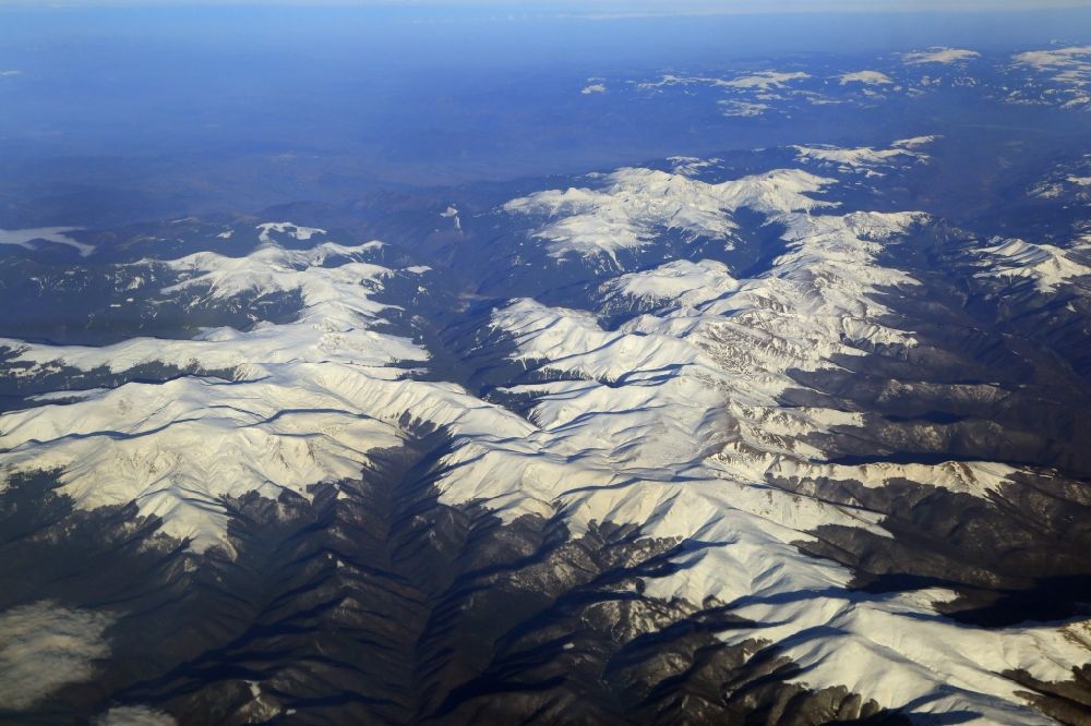 Aerial image Tarcu - Snow-covered mountain peaks in the area of Tarcu mountains in the Carpathians in Romania. The mountain landscape in the triangle of Bucharest, Cluj-Napoca and Timisoara is still largely undeveloped for tourism