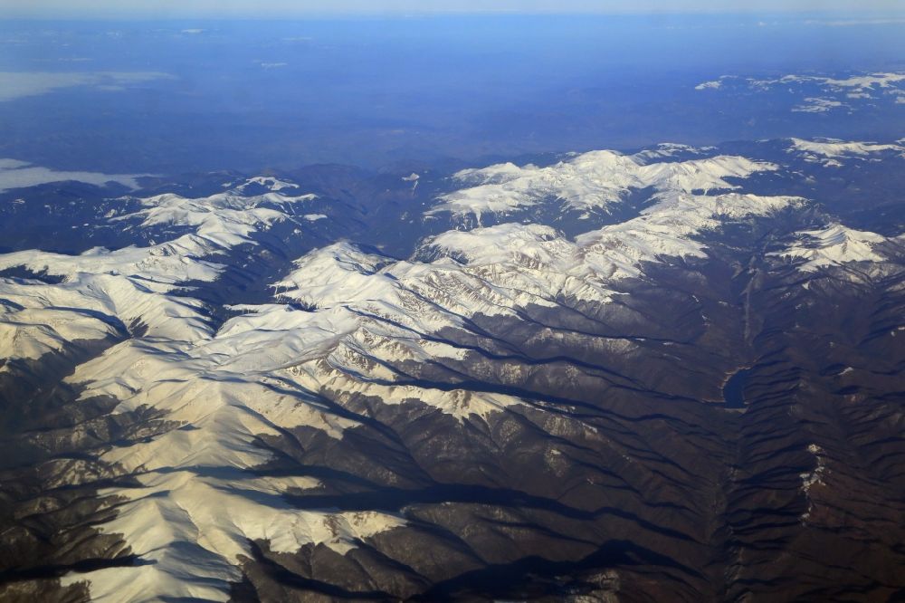 Tarcu from the bird's eye view: Snow-covered mountain peaks in the area of Tarcu mountains in the Carpathians in Romania. The mountain landscape in the triangle of Bucharest, Cluj-Napoca and Timisoara is still largely undeveloped for tourism
