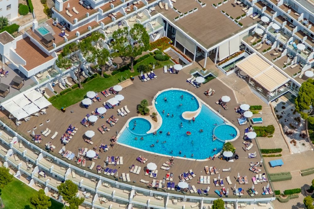 Aerial image Palmanova - Refreshing swim in the blue pool - swimming pool on the roof of the hotel building of the Aparthotel Ponent Mar on Carrer MarquA?s de la Torre in Palmanova in Balearic island of Mallorca, Spain