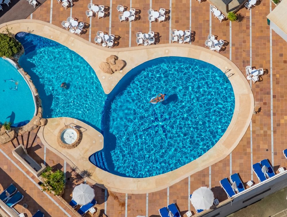 Llucmajor from above - Refreshing swim in the blue pool - swimming pool on the roof of the hotel Hotel Kilimanjaro on Carrer del Gran i General Consell in Llucmajor in Balearic island of Mallorca, Spain