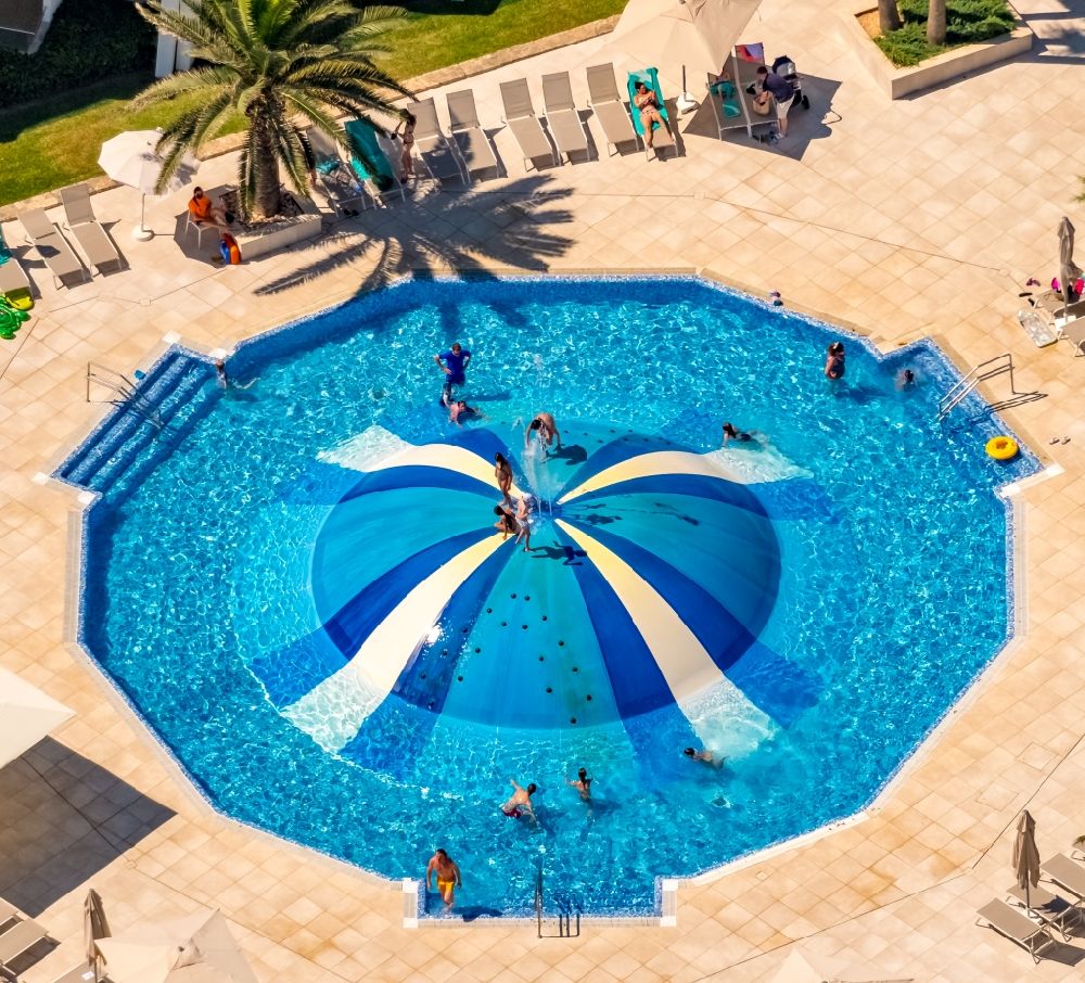 Aerial image Muro - Refreshing swim in the blue pool - swimming pool in Hotel La Cerveceria in Muro in Balearic island of Mallorca, Spain