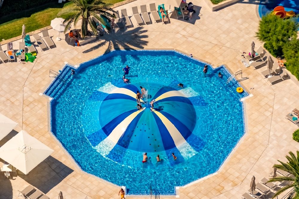 Aerial photograph Muro - Refreshing swim in the blue pool - swimming pool in Hotel La Cerveceria in Muro in Balearic island of Mallorca, Spain
