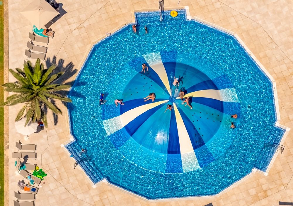 Muro from above - Refreshing swim in the blue pool - swimming pool in Hotel La Cerveceria in Muro in Balearic island of Mallorca, Spain