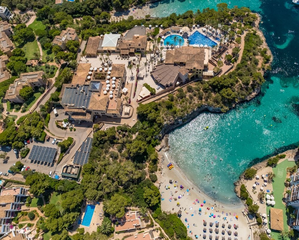 Cala D'or from above - Refreshing swim in the blue pool - swimming pool of Hotel Robinson Cala Serena in Cala D'or in Balearic island of Mallorca, Spain