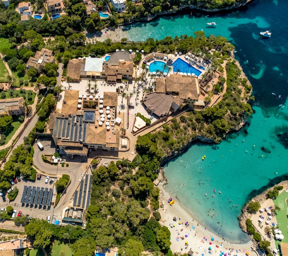 Cala D'or from above - Refreshing swim in the blue pool - swimming pool of Hotel Robinson Cala Serena in Cala D'or in Balearic island of Mallorca, Spain
