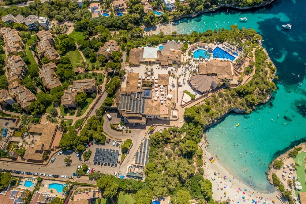 Cala D'or from the bird's eye view: Refreshing swim in the blue pool - swimming pool of Hotel Robinson Cala Serena in Cala D'or in Balearic island of Mallorca, Spain