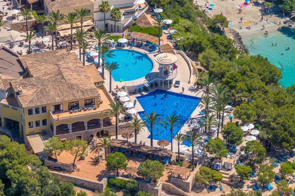 Aerial photograph Cala D'or - Refreshing swim in the blue pool - swimming pool of Hotel Robinson Cala Serena in Cala D'or in Balearic island of Mallorca, Spain
