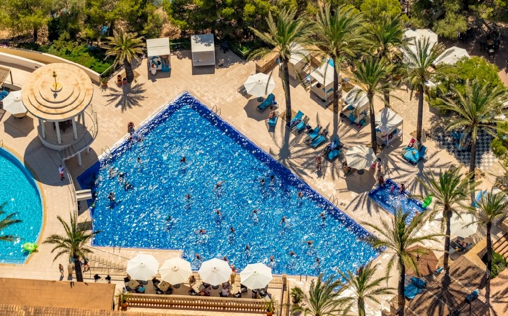 Aerial photograph Cala D'or - Refreshing swim in the blue pool - swimming pool of Hotel Robinson Cala Serena in Cala D'or in Balearic island of Mallorca, Spain