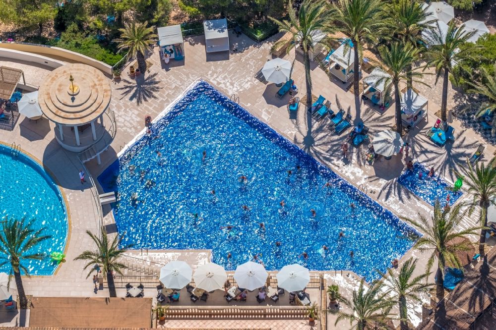 Cala D'or from the bird's eye view: Refreshing swim in the blue pool - swimming pool of Hotel Robinson Cala Serena in Cala D'or in Balearic island of Mallorca, Spain