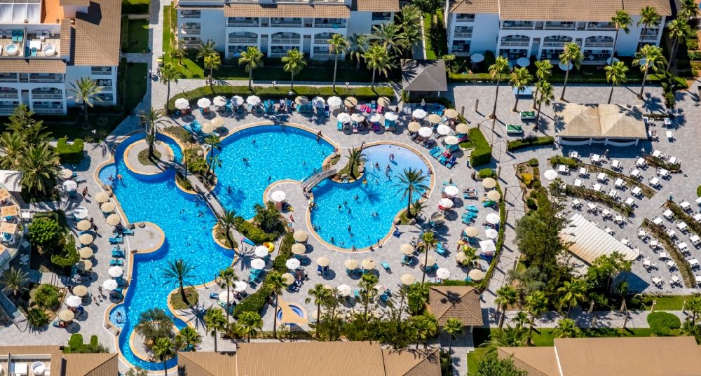 Aerial photograph Can Picafort - Refreshing swim in the blue pool - swimming pool of the hotel Playa Garden Selection Hotel & Spa on Avenida Platges de Muro in Can Picafort in Balearic island of Mallorca, Spain