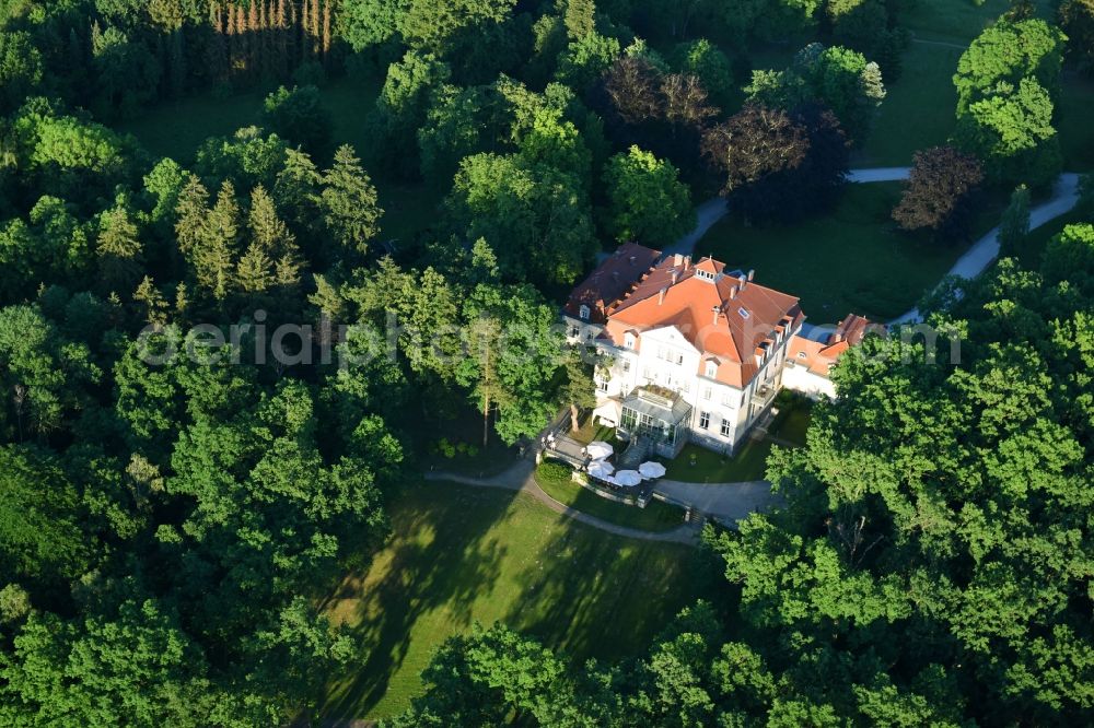 Liebenberg from the bird's eye view: The sea house in the big Lanke lake in the midst of a park with own sea access and footbridge surrounded from a woodland with dear mountain in the Loewenberger country in the federal state Brandenburg