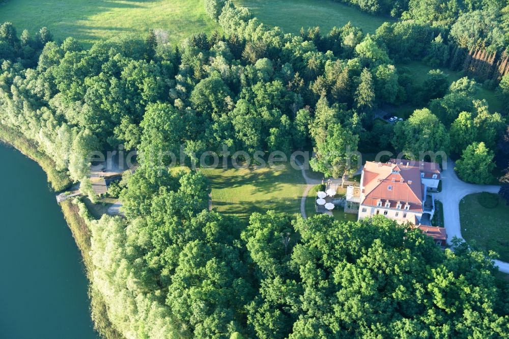 Aerial image Liebenberg - The sea house in the big Lanke lake in the midst of a park with own sea access and footbridge surrounded from a woodland with dear mountain in the Loewenberger country in the federal state Brandenburg