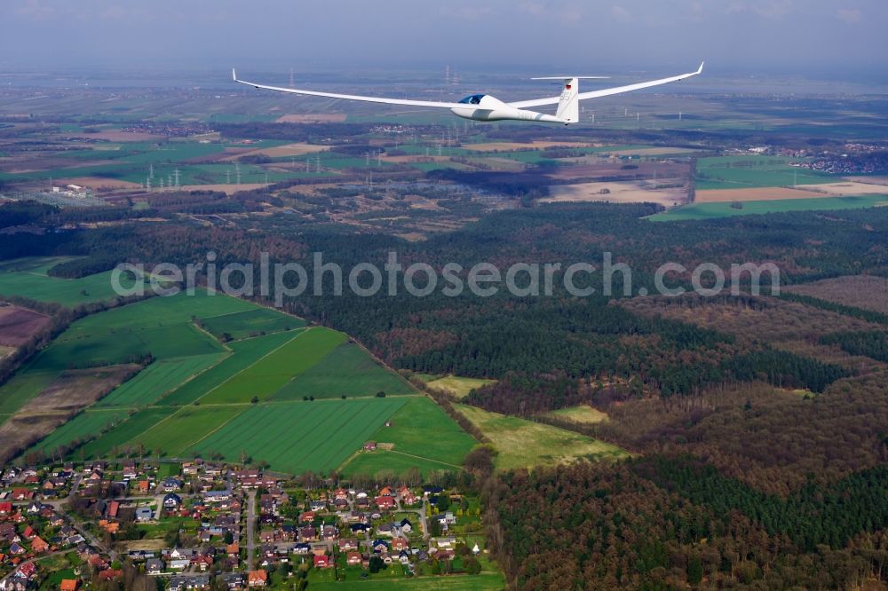 Deinste from above - Glider and sport aircraft Duo Discus D-KBFV flying over airspace of Stade in the evening light in Lower Saxony, Germany. This glider is equipped with a small auxiliary engine behind the cockpit in order to be able to reach the home airfield in case of bad thermals