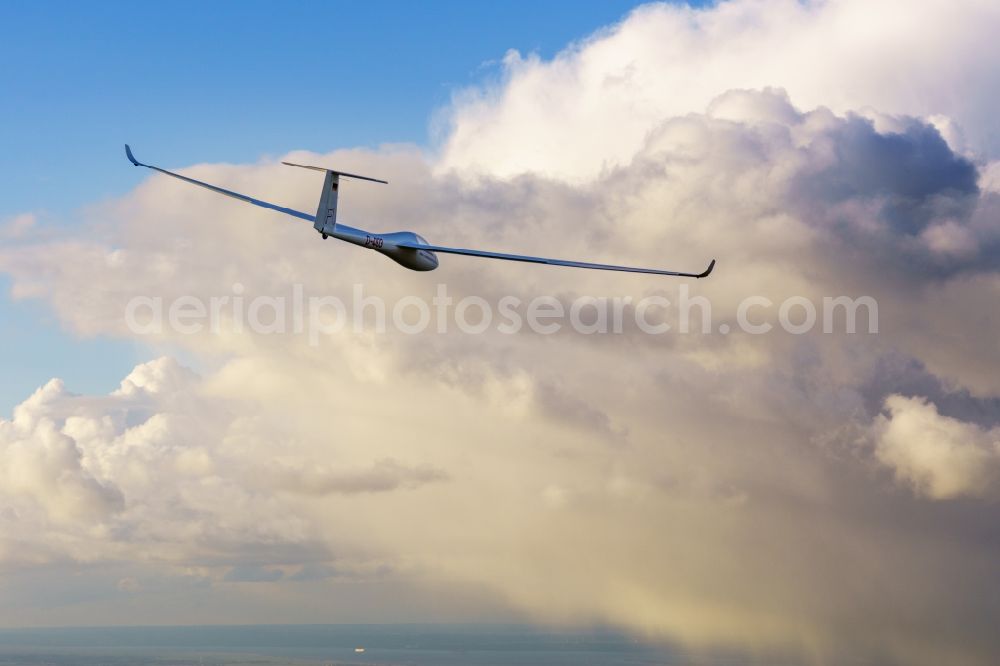 Deinste from the bird's eye view: Glider and sport aircraft LS-4 D-4103 flying in front of rain clouds over the airspace of Deinste in the state Lower Saxony, Germany