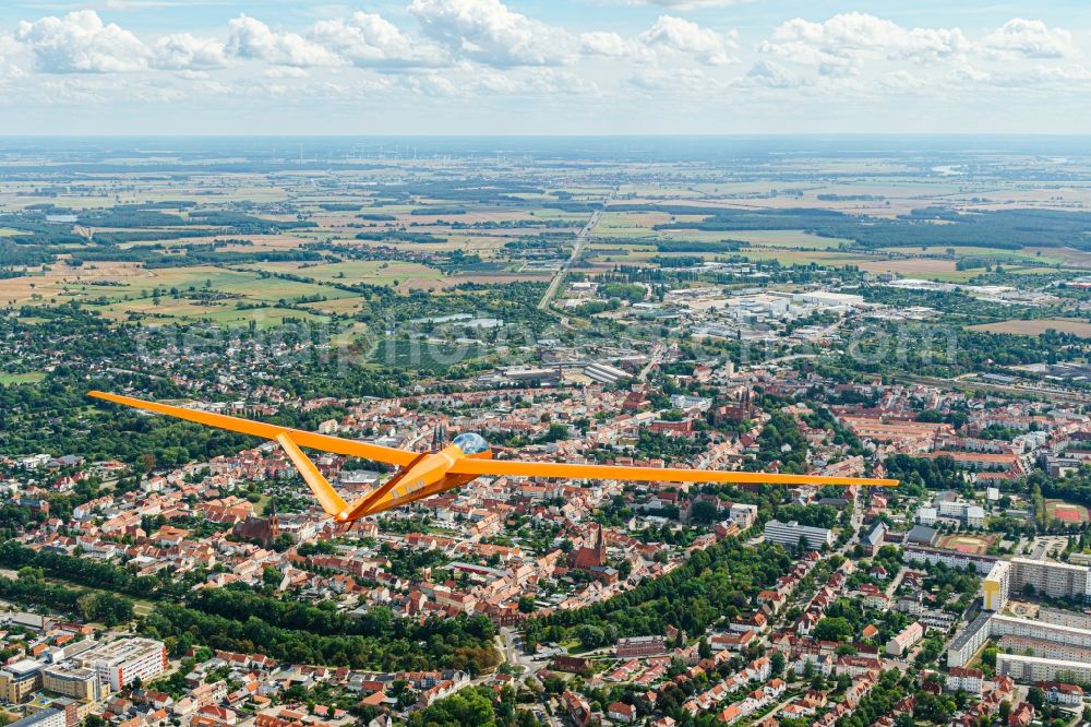 Stendal from the bird's eye view: Glider and sport aircraft Mue 22 b with calling by D-1848 flying over the airspace in Stendal in the state Saxony-Anhalt, Germany