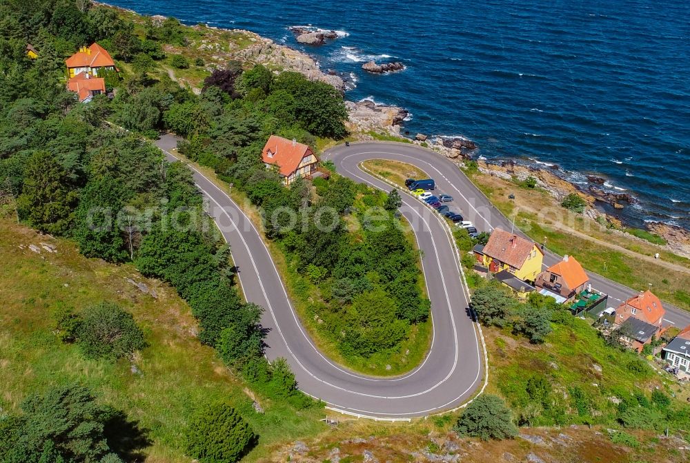Aerial image Gudhjem - Serpentine-shaped curve of a road guide on the shores of the Baltic Sea in Gudhjem in Region Hovedstaden, Denmark