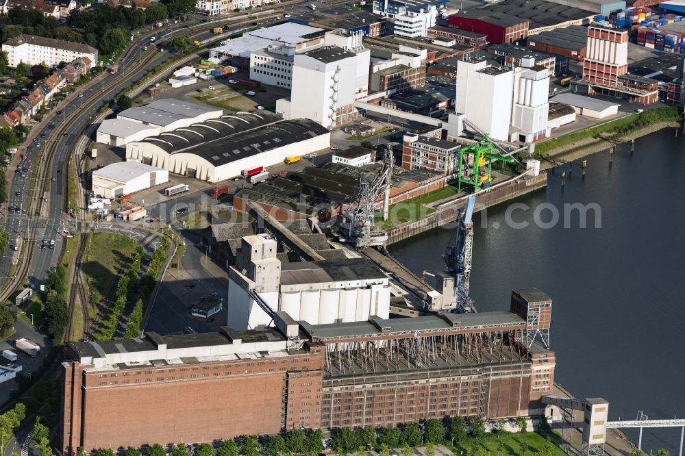 Aerial photograph Bremen - High silo and grain storage with adjacent storage of J. Mueller Weser GmbH & Co. KG on street Getreidestrasse in the district Ueberseestadt in Bremen, Germany