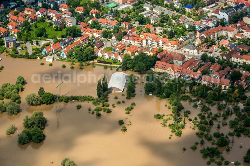 Aerial image Radebeul - The situation during the flooding in East Germany on the bank of the river Elbe at the city limits of Radebeul in the free state of Saxony. View on residential areas and multi family buildings. The flooded area normally consists of allotments, sports grounds, forest and fields