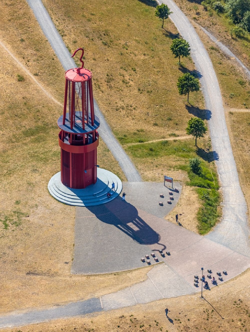 Aerial image Moers - Sculpture of an oversized red miner's lamp on the grounds of renatured Halde Rheinpreussen in Moers in North Rhine-Westphalia