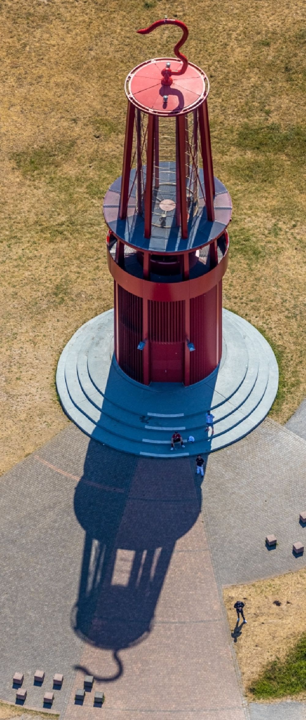 Aerial image Moers - Sculpture of an oversized red miner's lamp on the grounds of renatured Halde Rheinpreussen in Moers in North Rhine-Westphalia