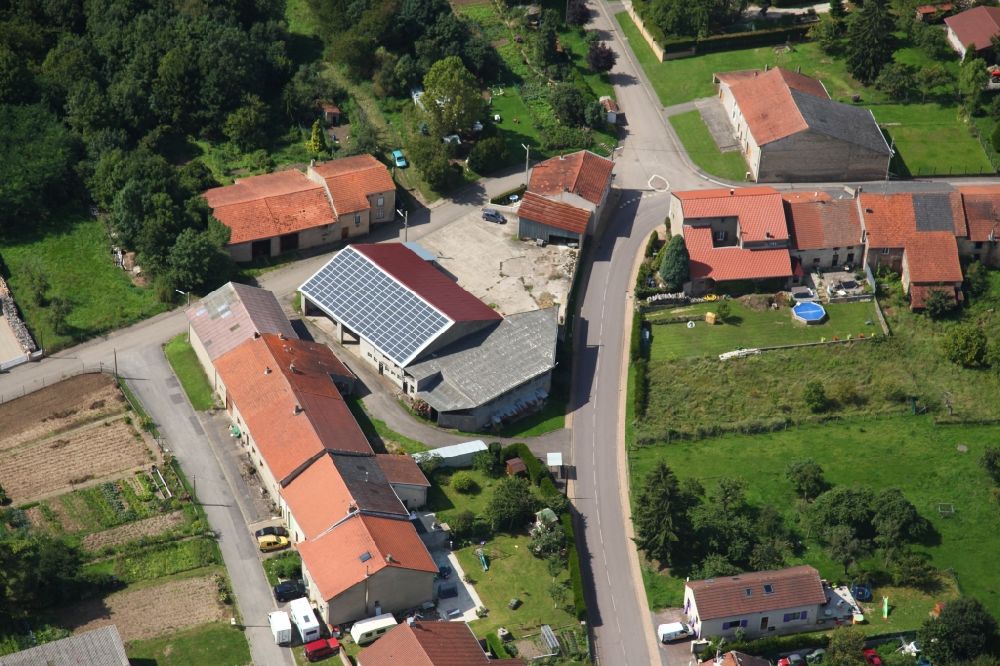 Aerial image Piblange - Solar power plant and photovoltaic system on the roof of a barn in Piblange in Grand Est, France