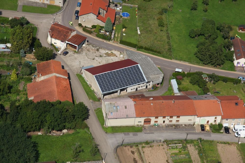 Aerial photograph Piblange - Solar power plant and photovoltaic system on the roof of a barn in Piblange in Grand Est, France