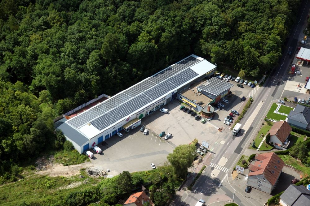 Aerial image Sarreguemines - Solar power plant and photovoltaic system on the roof of retail stores in Sarreguemines in Grand Est, France