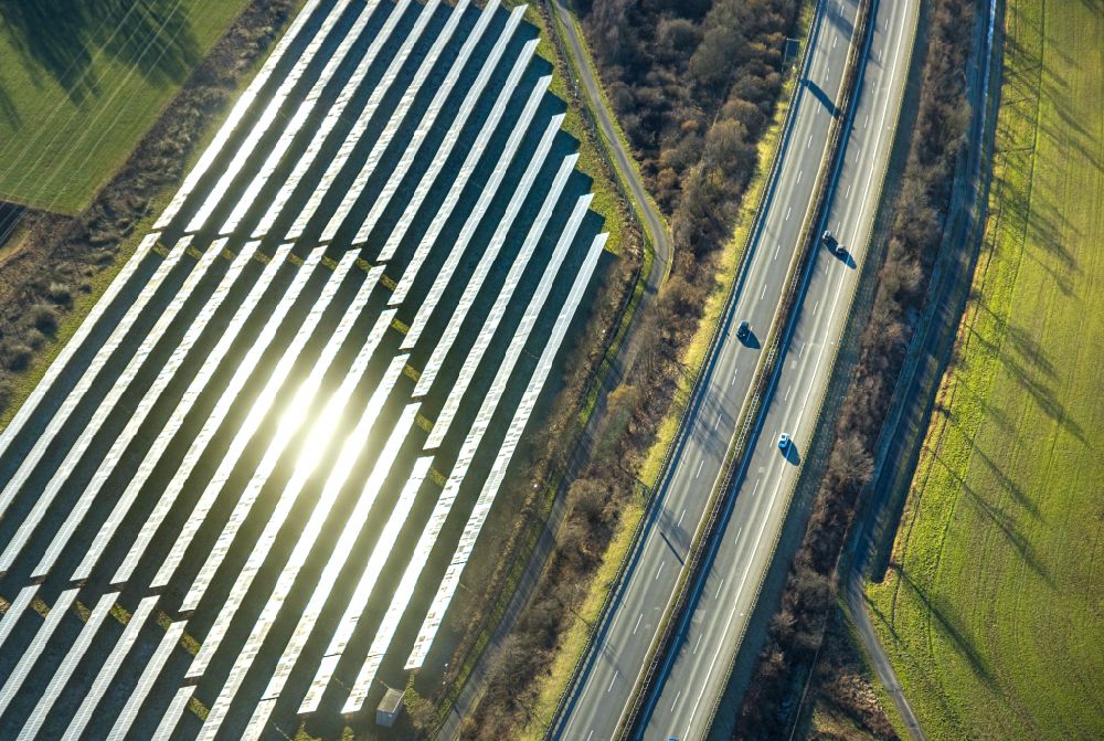 Enste from above - Rows of panels of a solar power plant and photovoltaic system on Autobahn BAB A46 in Enste at Sauerland in the state North Rhine-Westphalia, Germany