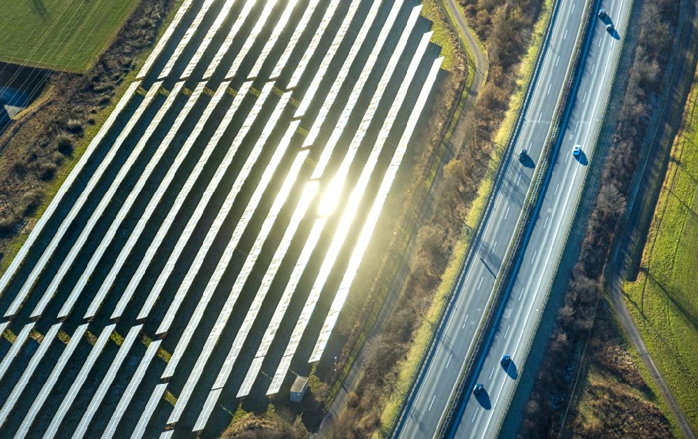 Enste from the bird's eye view: Rows of panels of a solar power plant and photovoltaic system on Autobahn BAB A46 in Enste at Sauerland in the state North Rhine-Westphalia, Germany