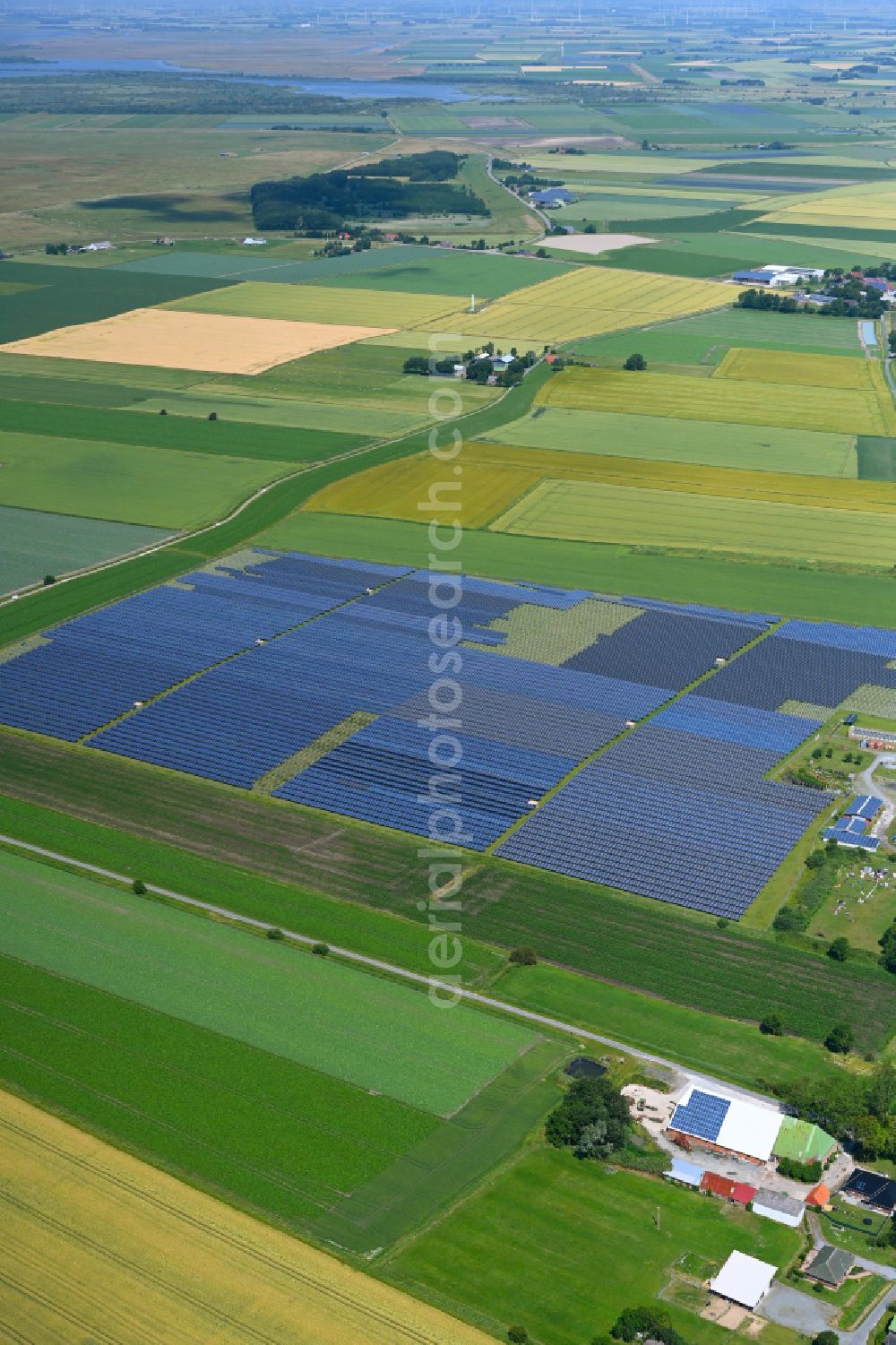 Busenwurth from above - Panel rows of a solar power plant and photovoltaic system of the PV Betriebs Waste to Energy A UG & Co. KG in a field on the Alte Landstrasse in Busenwurth in the state Schleswig-Holstein, Germany