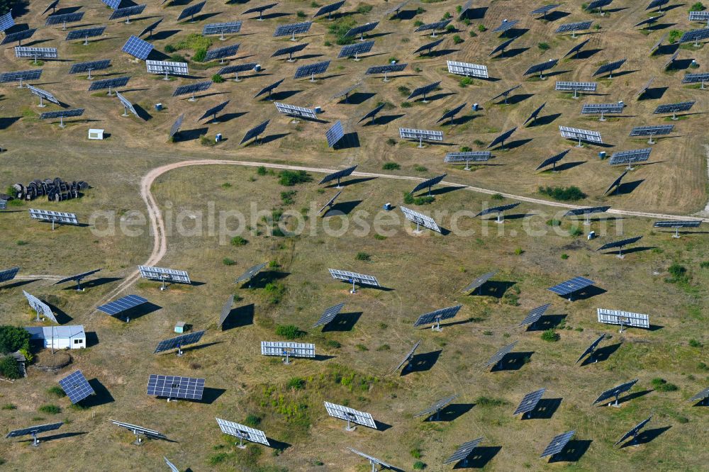 Frohnsdorf from the bird's eye view: Rows of panels of a solar power plant and photovoltaic system on a field in Frohnsdorf in the state Brandenburg, Germany