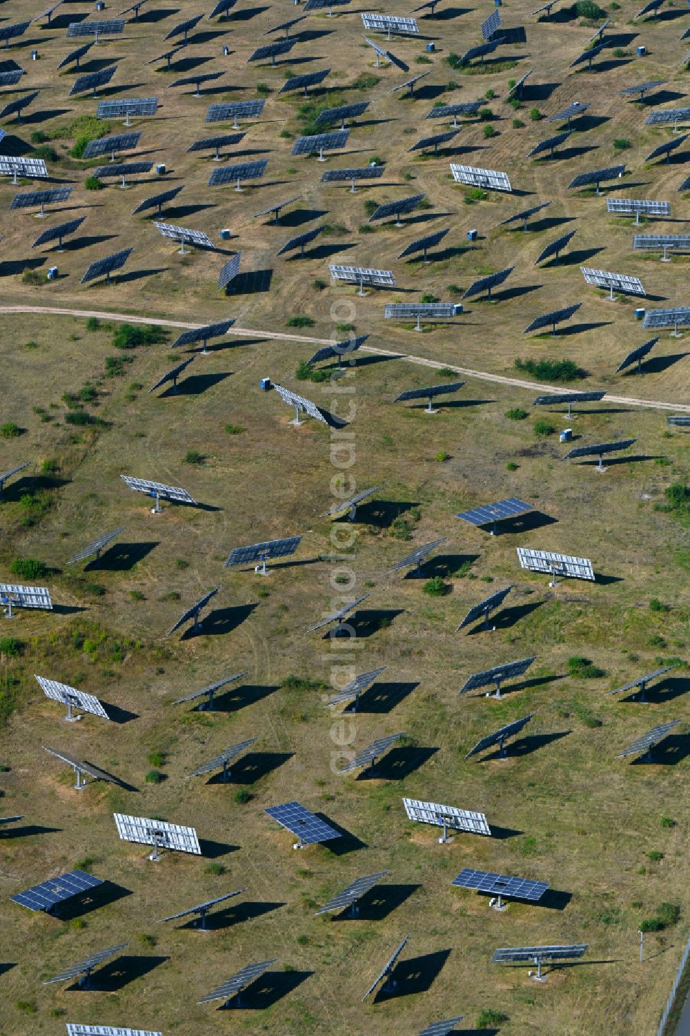 Aerial image Frohnsdorf - Rows of panels of a solar power plant and photovoltaic system on a field in Frohnsdorf in the state Brandenburg, Germany