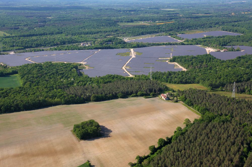 Gien from above - Rows of panels of a solar power plant and photovoltaic system on a field in Gien in Centre, France