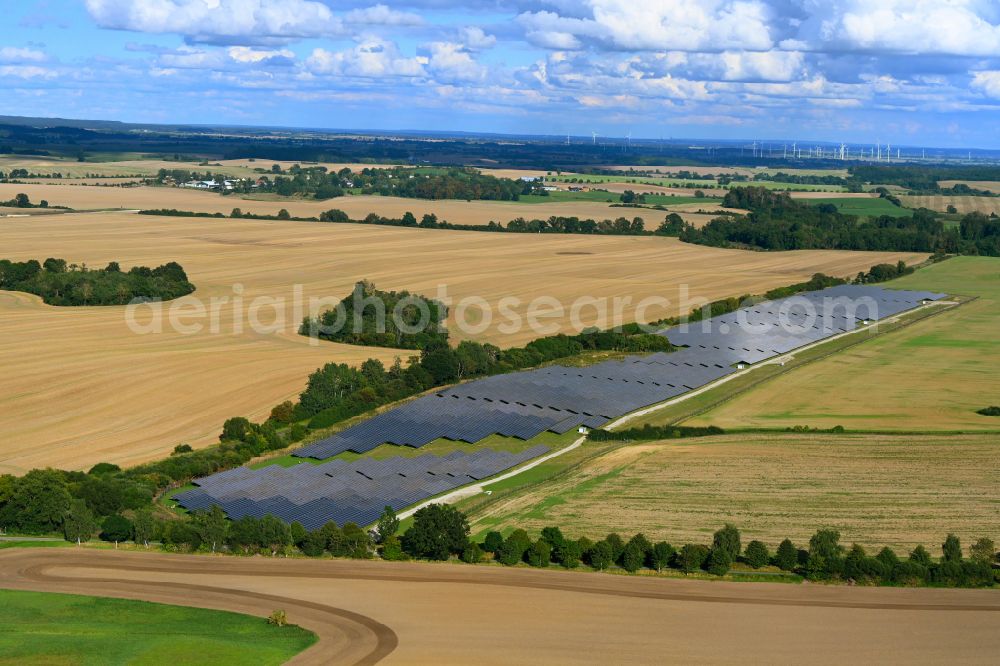 Aerial image Helpt - Rows of panels of a solar power plant and photovoltaic system on a field on street Dorfstrasse in Helpt in the state Mecklenburg - Western Pomerania, Germany