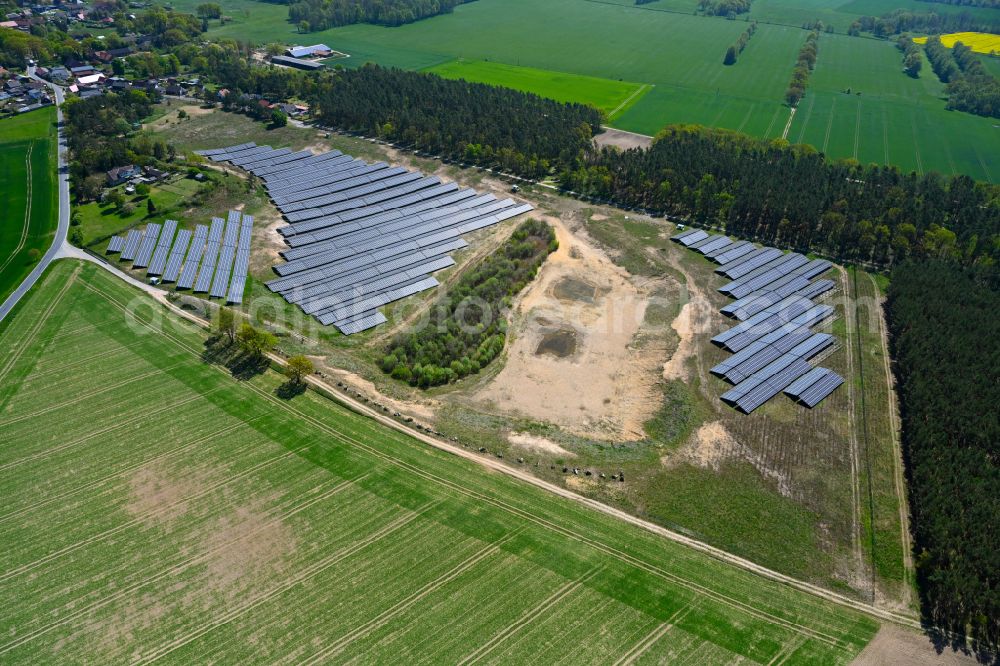 Lohne from above - Rows of panels of a solar power plant and photovoltaic system on a field in Lohne in the state Saxony-Anhalt, Germany