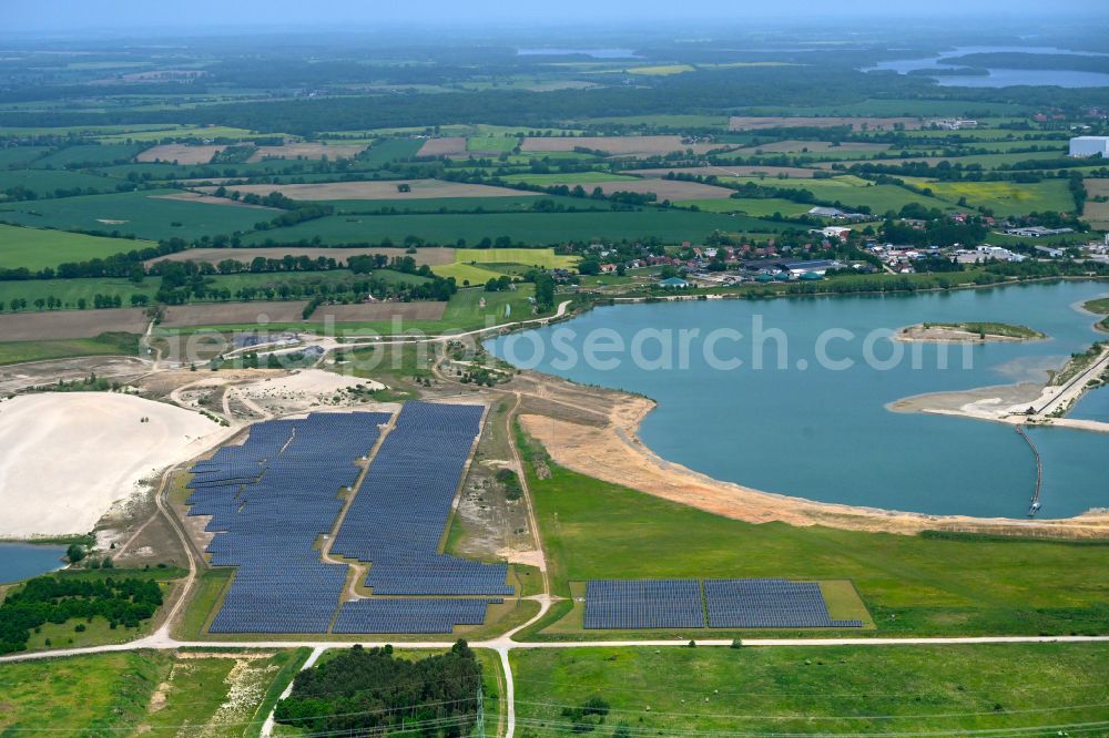 Aerial image Lüttow-Valluhn - Rows of panels of a solar power plant and photovoltaic system on a field in Luettow-Valluhn in the state Mecklenburg - Western Pomerania, Germany