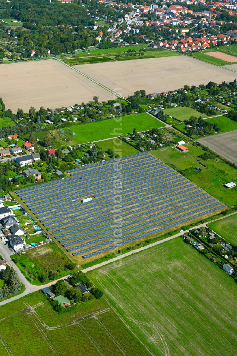Quesitz from above - Rows of panels of a solar power plant and photovoltaic system on a field in Quesitz in the state Saxony, Germany
