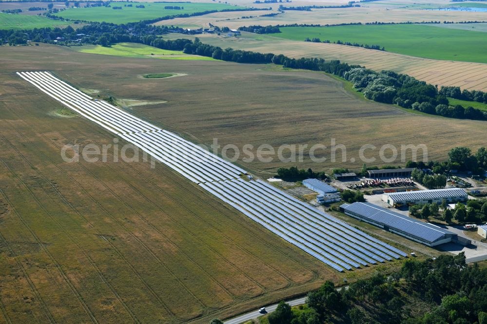 Dedelow from above - Solar power plant and photovoltaic systems on the former runway with the tarmac area of the airfield in Dedelow in the state Brandenburg, Germany