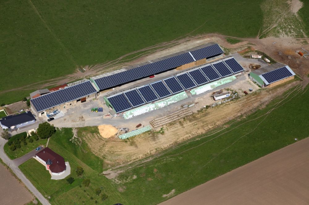 Aerial photograph Varize - Solar power plant and photovoltaic systems on the roofs of a rural property in Varize in Grand Est, France