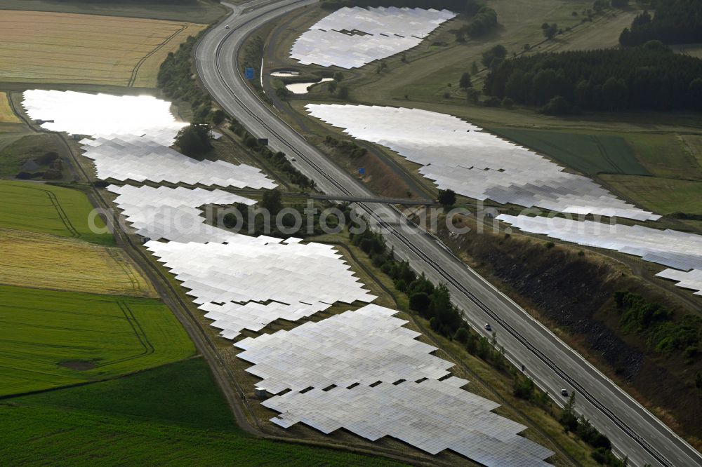 Gattendorf from the bird's eye view: Photovoltaic system and solar power plant - rows of panels on the edge of the lanes of the motorway route and route of the BAB A 93 in Gattendorf in the state Bavaria, Germany